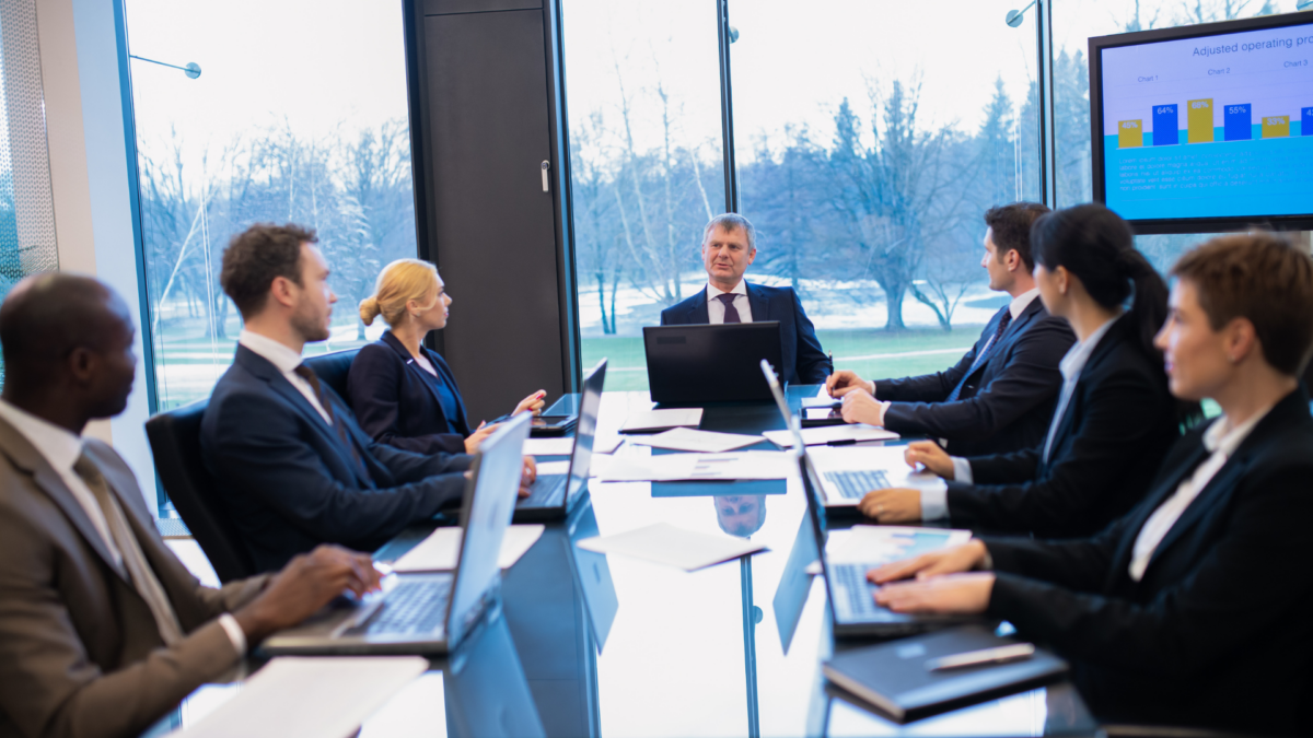 Business people sitting around a conference table